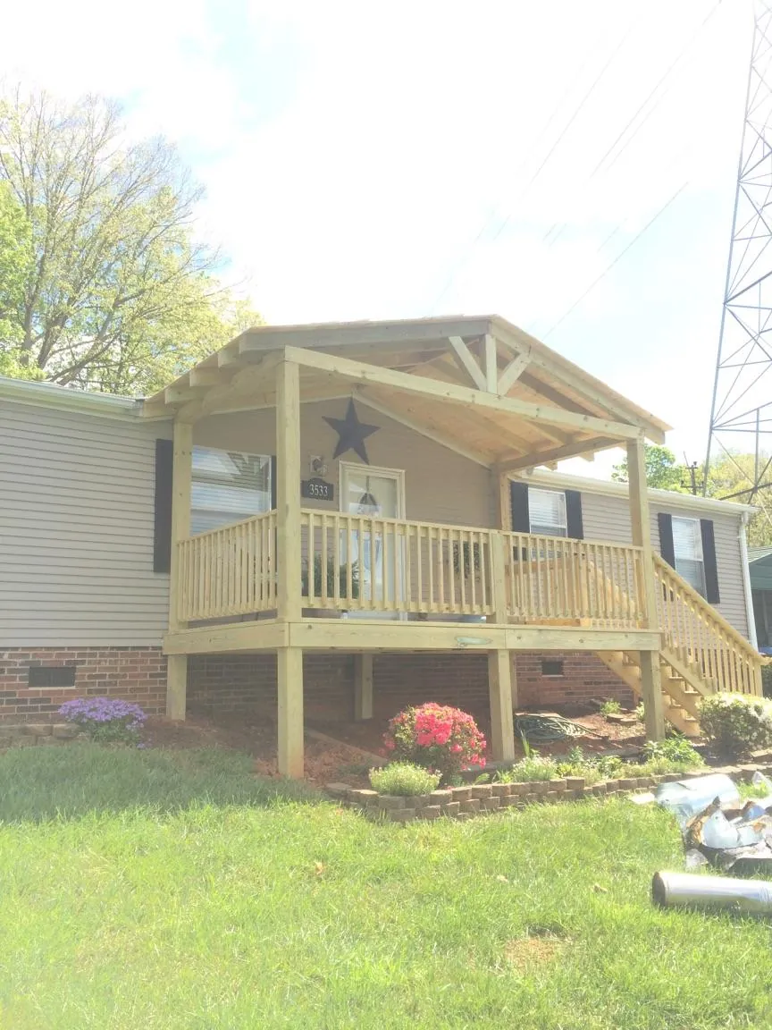 New gabled porch roof and deck railing added to a ranch home in Stanwood